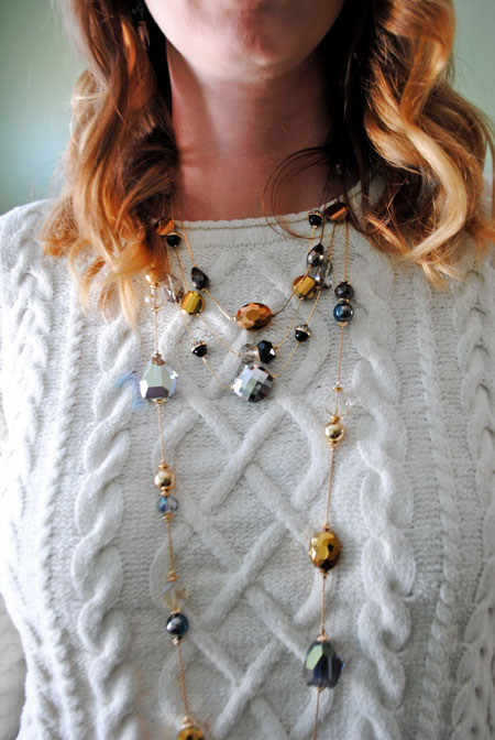 Sweater with layered necklaces